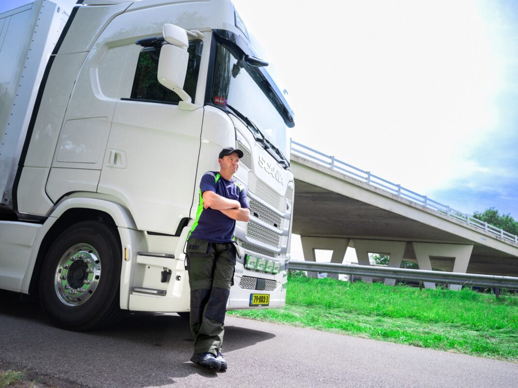 Man leunend tegen truck